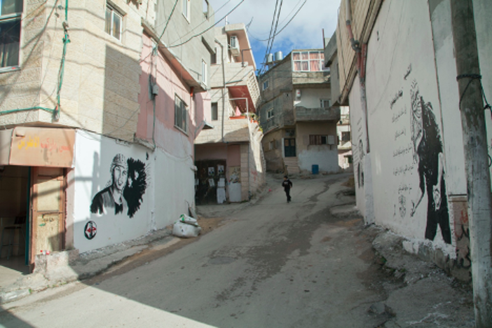 . Left: Ahmed Hmeedat, Mural for Jihad al-Jaafary, 20, who was killed in 2015 while standing on his rooftop during a raid. Right: anonymous mural for Jihad al-Jaafary. Photograph © 2015 Margaret Olin.